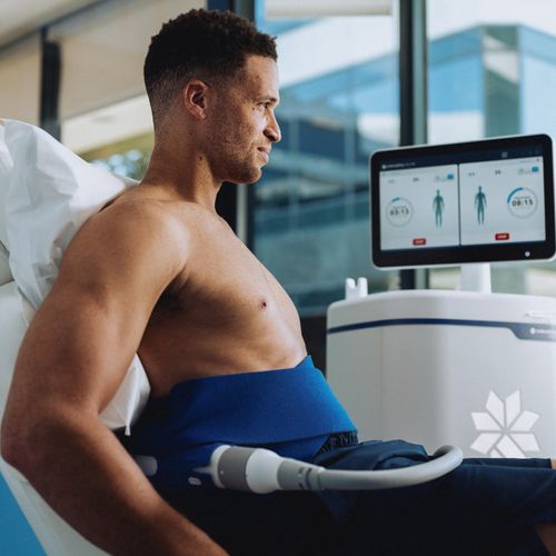 A man receiving a non-invasive body-sculpting treatment around his abdomen